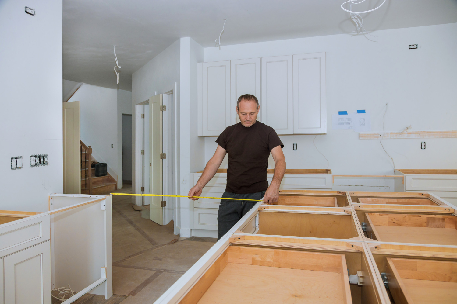 Man using tape measure for measuring storage.